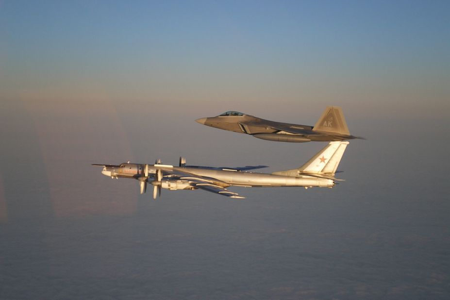 A U.S. Air Force F-22 Raptor, top, escorts a Russian Air Force Tu-95 bomber off the coast of Alaska in 2011. 