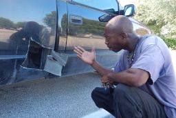 Errand Frazier shows where he cut open his pickup truck to rescue a kitten.