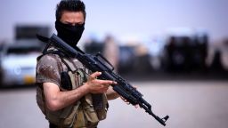 A masked Pershmerga fighter from Iraq's autonomous Kurdish region guards a temporary camp set up to shelter Iraqis fleeing violence in the northern Nineveh province, in Aski kalak, 40 kms west of the region's capital Arbil, on June 13, 2014. Thousands of people who fled Iraq's second city of Mosul after it was overrun by jihadists have been queuing in the blistering heat, hoping to enter the safety of the nearby Kurdish region and furious at Baghdad's failure to help them.
AFP PHOTO/SAFIN HAMED        (Photo credit should read SAFIN HAMED/AFP/Getty Images)