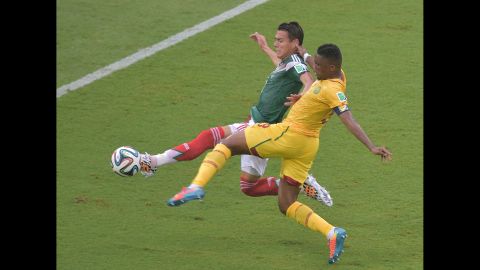Moreno, in green, knocks the ball away from Cameroon forward Samuel Eto'o.