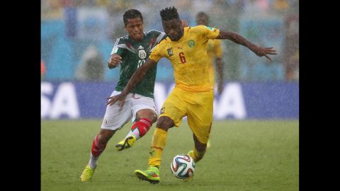 Song controls the ball as Mexico's Giovani dos Santos, left, challenges him.