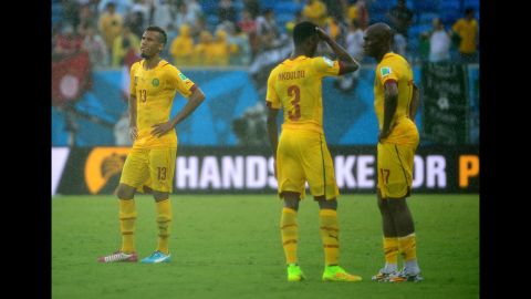From left, Cameroon players Eric Maxim Choupo-Moting, Nicolas N'Koulou and Stephane Mbia react at the end of match.