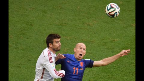 Pique and Robben eye a ball in the air.