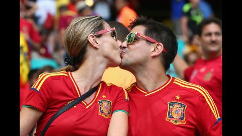 Two Spain fans kiss before the match. 