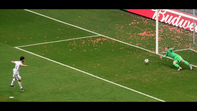 Xabi Alonso scores on a penalty kick to give Spain an early 1-0 lead.