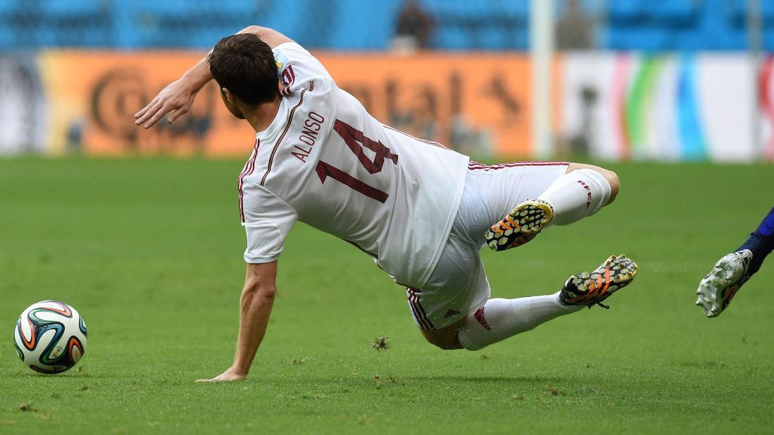 Spanish midfielder Xabi Alonso takes a fall during the first half.