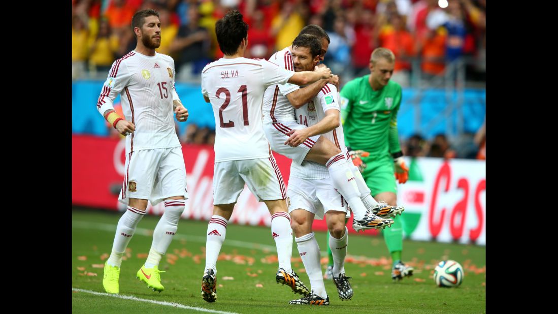 Alonso holds a teammate as Spain celebrates its first goal.
