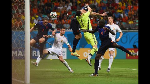 Stefan de Vrij, left, deflects the ball in for the Netherlands' third goal while van Persie collides with Spanish goalkeeper Iker Casillas.
