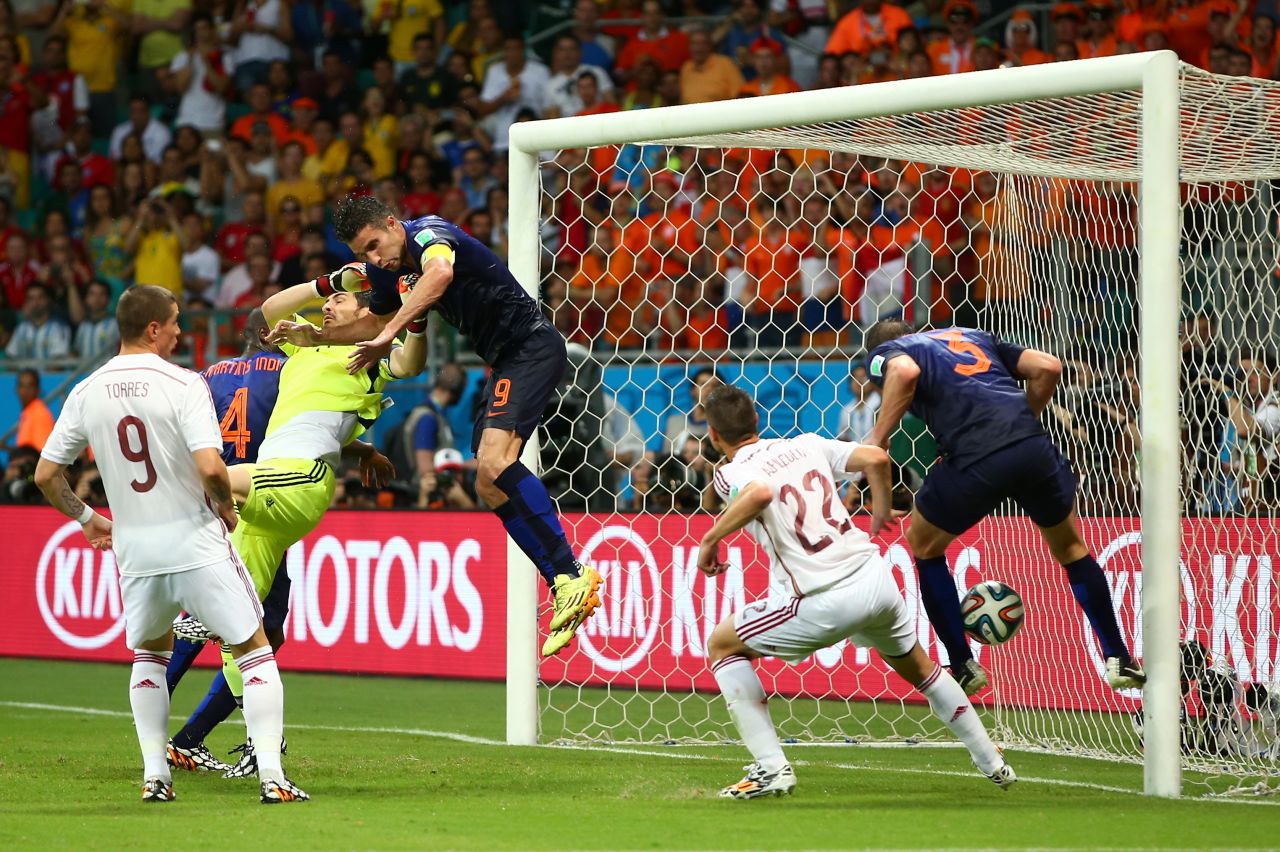 Stefan de Vrij, right, deflects the ball in for the Netherlands' third goal while van Persie collides with Spanish goalkeeper Iker Casillas.