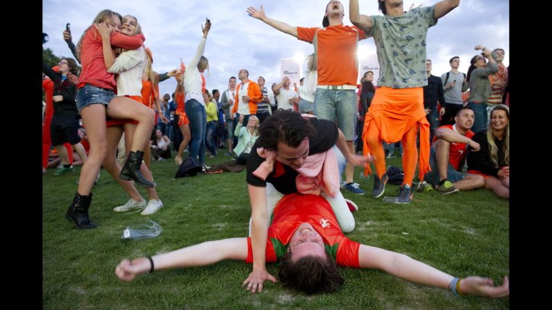 Dutch fans cheer in Amsterdam, Netherlands, after watching their soccer team demolish Spain 5-1.