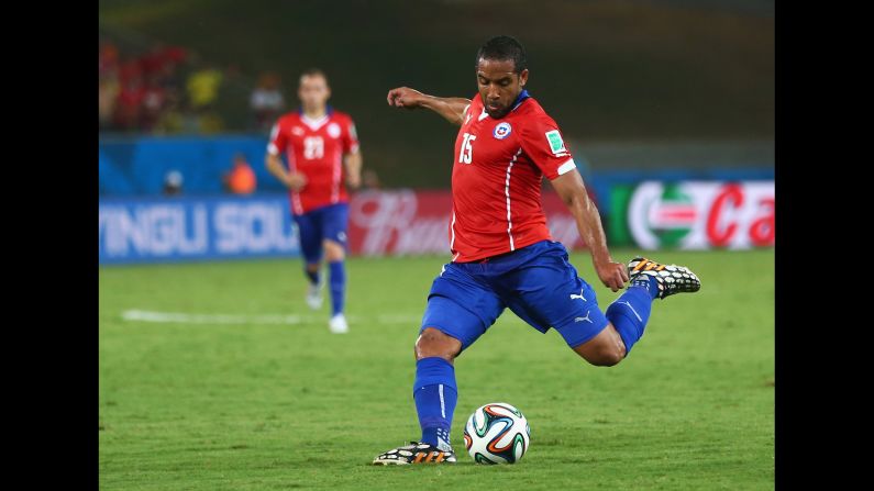 Jean Beausejour of Chile shoots and scores the final goal during his team's 3-1 win over Australia on Friday, June 13, in Cuiaba, Brazil.