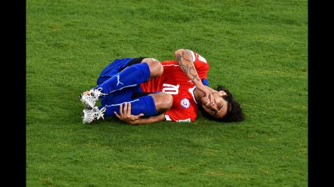 Jorge Valdivia of Chile lies on the field after a foul.