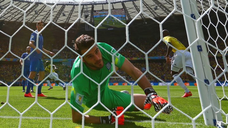 Greece goalkeeper Orestis Karnezis fails to keep out a deflected shot by Colombia's Pablo Armero in the fifth minute of the match.