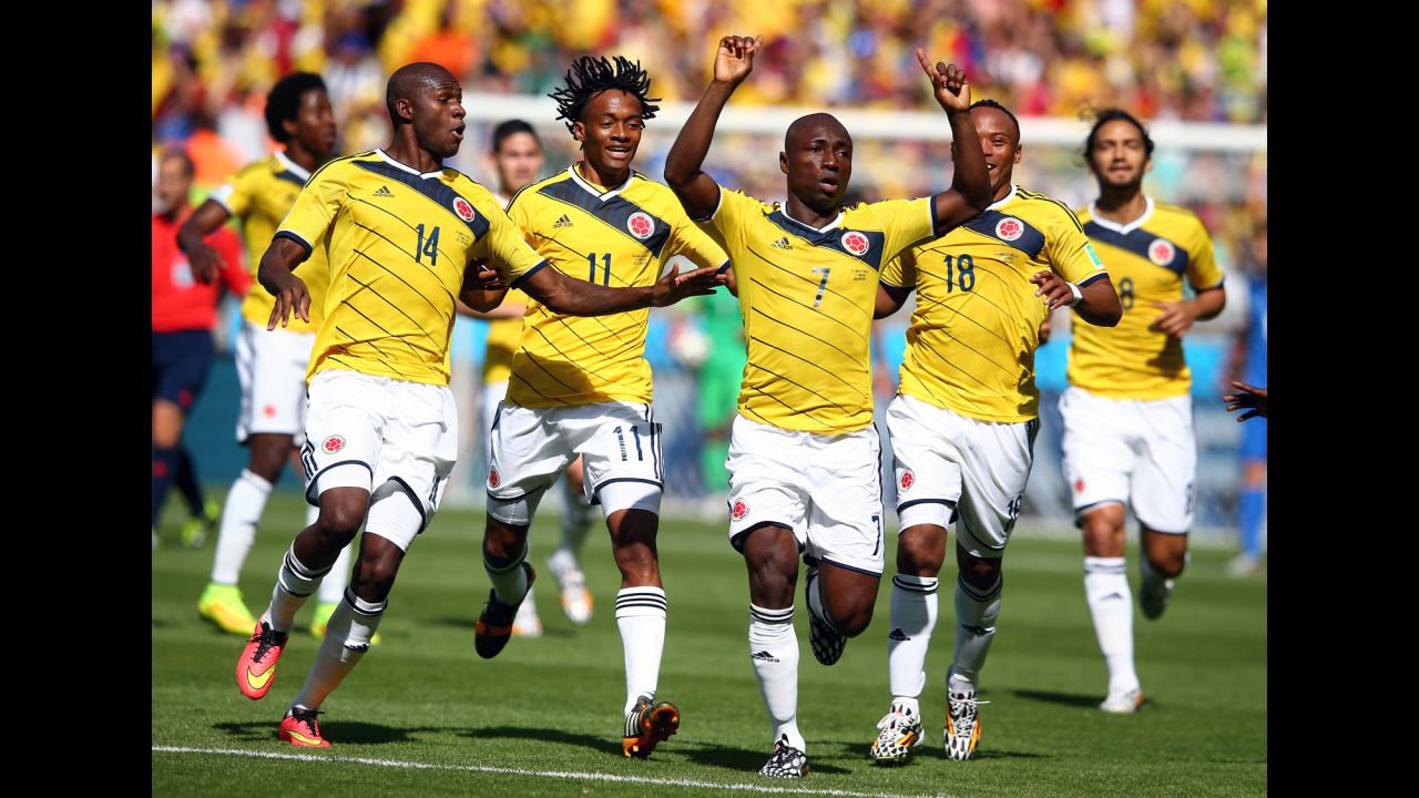 Pablo Armero of Colombia, center, celebrates with teammates after scoring the opening goal.