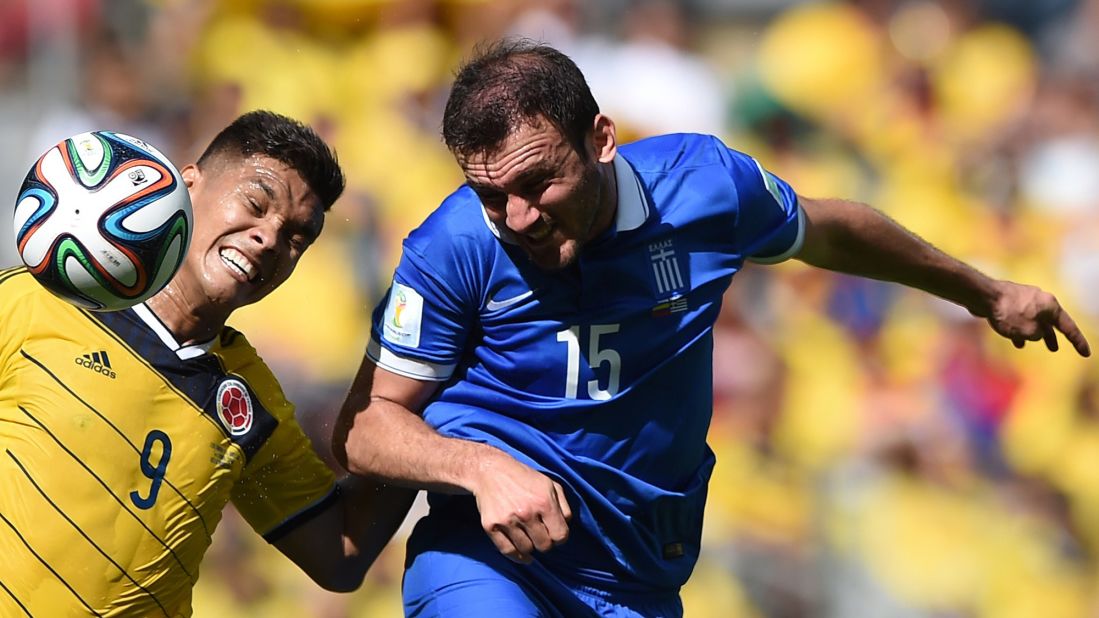 Greece's defender Vasilis Torosidis, right, vies with Colombia's forward Teofilo Gutierrez.