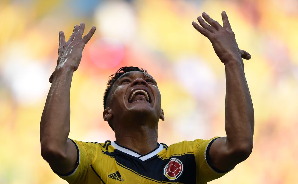 Colombia forward Teofilo Gutierrez celebrates after scoring his team's second goal against Greece.
