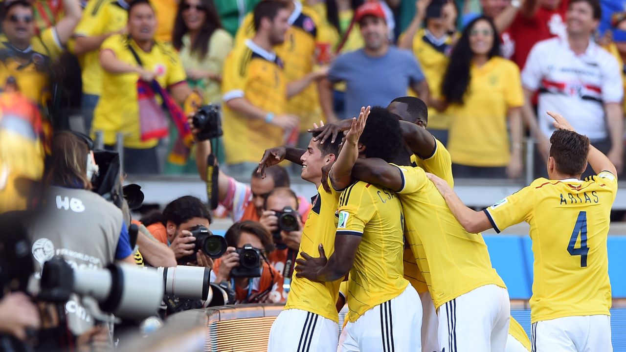 Colombia midfielder James Rodriguez, left, celebrates with teammates after scoring at Estadio Mineirao in Belo Horizonte, Brazil.  Colombia defeated Greece 3-0. 