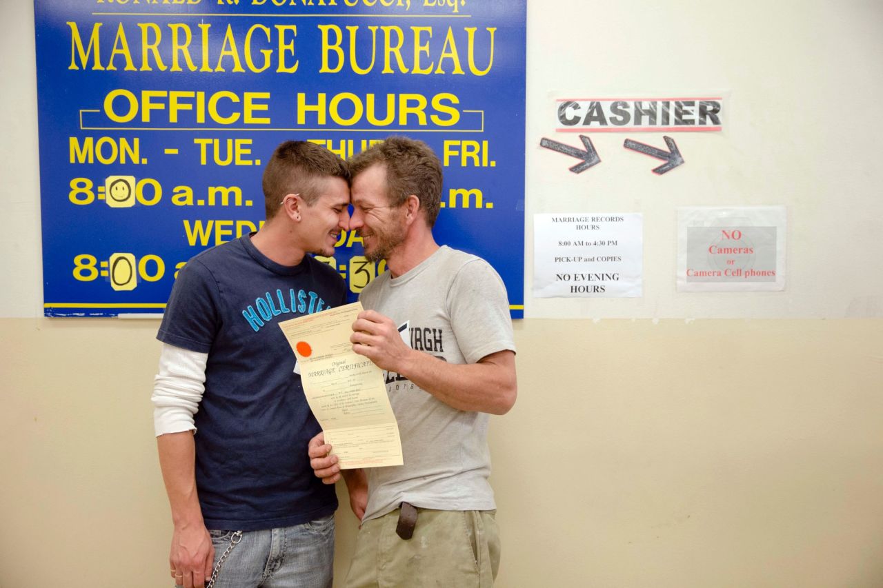 William Roletter, left, and Paul Rowe get close after having their photo taken with their marriage certificate May 21, 2014, at Philadelphia City Hall.
