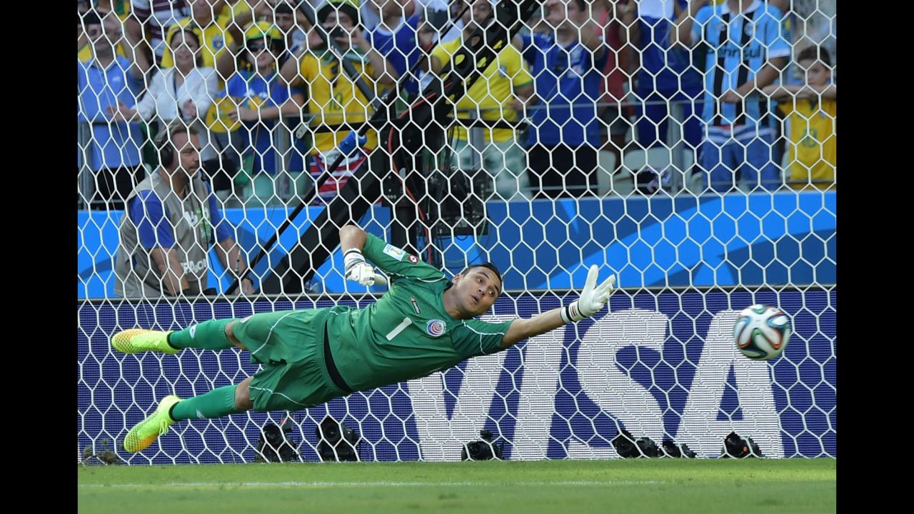 Costa Rica's goalkeeper Keylor Navas fails to save Edinson Cavani's penalty kick.
