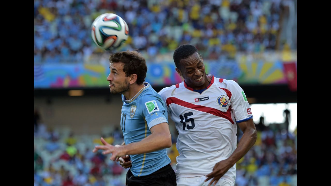 Uruguay forward Christian Stuani, left, and Costa Rica defender Junior Diaz vie for the ball. 