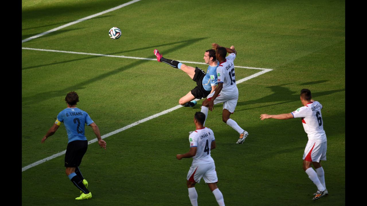 Uruguay defender Diego Godin, top center, has a goal disallowed for offside.