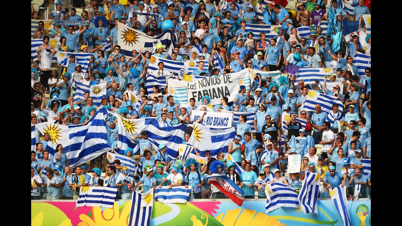 Uruguay fans hold up their country's flags before the game. 