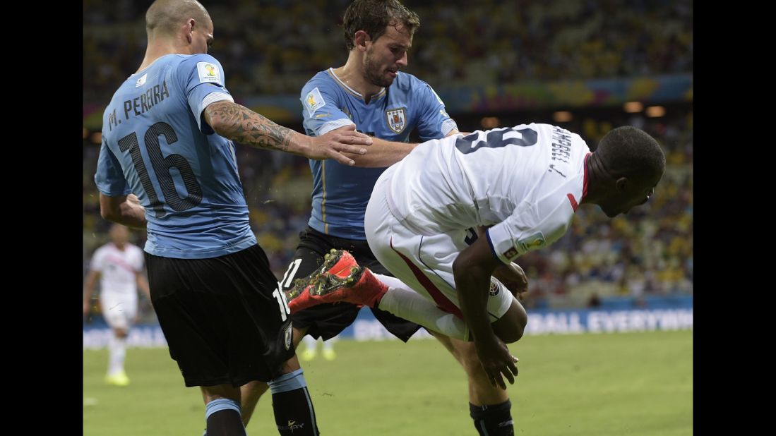 Uruguay defender Maximiliano Pereira, left, is sent off after this tackle on Costa Rica forward Joel Campbell during a World Cup match at Castelao in Fortaleza, Brazil. 