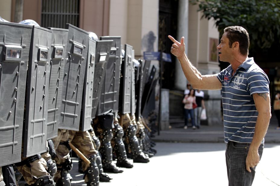 A demonstrator argues with police during a protest against the World Cup in Belo Horizonte, Brazil, on Saturday, June 14. The buildup to the World Cup has been plagued by mass demonstrations over the estimated $11 billion cost of staging the football tournament. Many protesters, angered by the state of Brazil's public services, believe the money would have been better spent elsewhere.