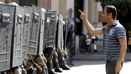A demonstrator argues with police lined up during a protest against the World Cup in Belo Horizonte, Brazil, on Saturday, June 14. Anti-World Cup demonstrators are demanding better public services and protesting the money spent on the international soccer tournament.