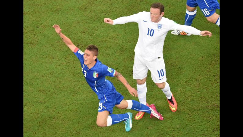Italy midfielder Marco Verratti, left, falls following a tackle by England forward Wayne Rooney.
