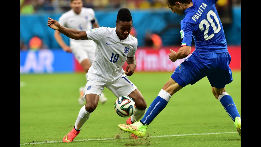 England midfielder Raheem Sterling, left, tries to run past Italy defender Gabriel Paletta.