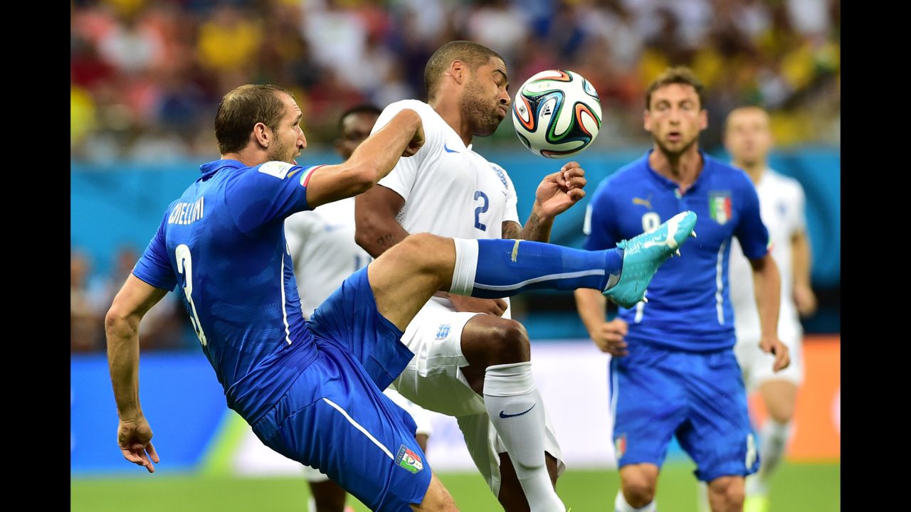 Italy defender Giorgio Chiellini and England full back Glen Johnson vie for the ball. 