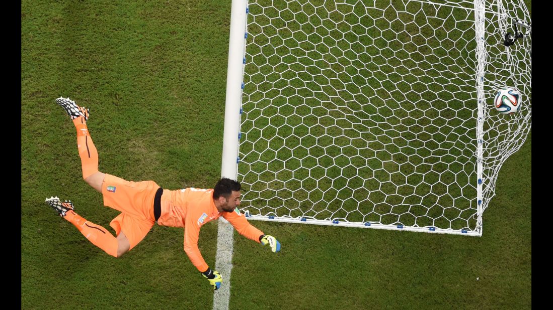 Italy goalkeeper Salvatore Sirigu sees an early England shot fly into the sidenetting.