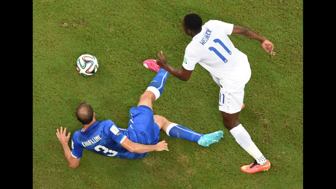 Italy's defender Giorgio Chiellini, left, and England's forward Daniel Welbeck vie for the ball.