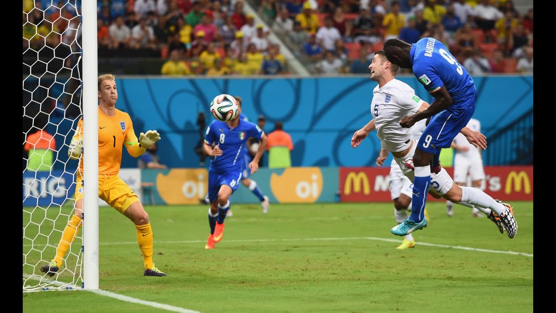 Mario Balotelli scores Italy's second goal, beating England defender Gary Cahill to a cross and heading the ball past goalkeeper Joe Hart.
