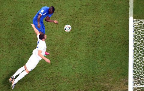 Italy striker Mario Balotelli, left, heads the winning goal against England on June 14. Italy defeated England 2-1 in Manaus, Brazil.