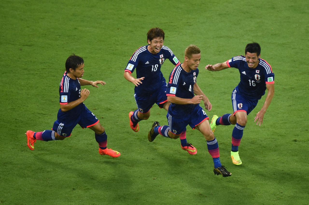 Keisuke Honda, second from right, celebrates scoring Japan's first goal with teammates Yuto Nagatomo, Yuya Osako and Hotaru Yamaguchi.