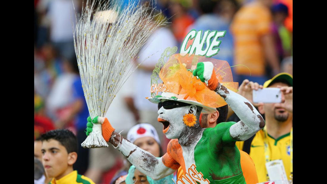 A fan of the Ivory Coast cheers in the crowd during the match. 