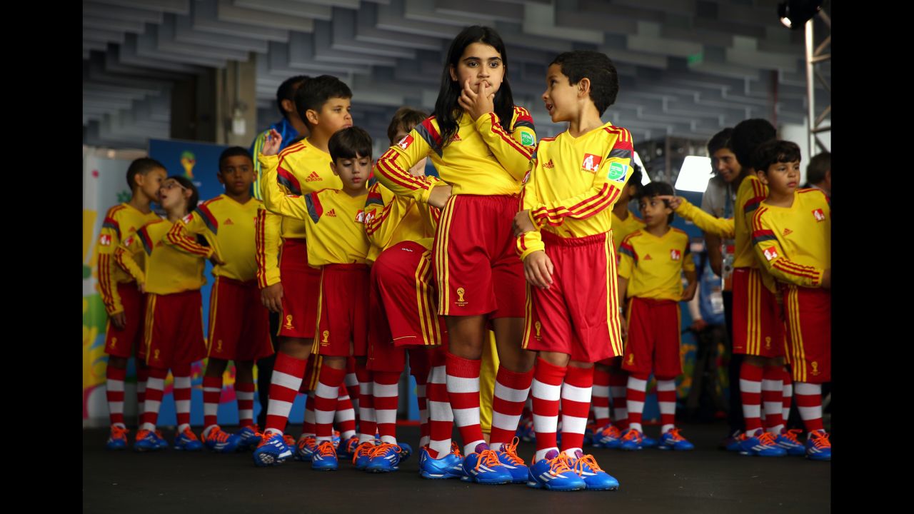Young team mascots prepare to enter the pitch with the players prior to the match. 