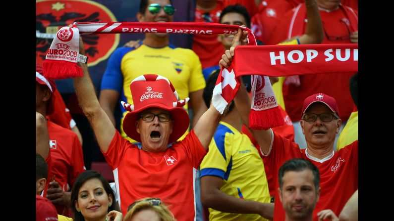 Swiss fans cheer and hold up banners during the game. <a href="index.php?page=&url=http%3A%2F%2Fwww.cnn.com%2F2014%2F06%2F14%2Ffootball%2Fgallery%2Fworld-cup-0614%2Findex.html">See the best World Cup photos from June 14.</a>