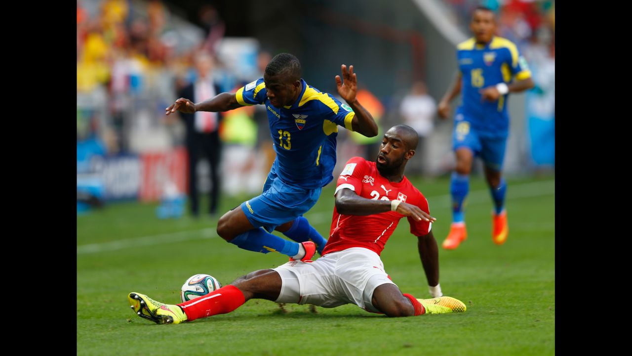 Johan Djourou of Switzerland tackles Enner Valencia of Ecuador