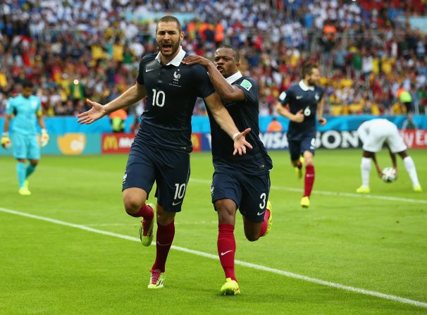 Benzema celebrates with Patrice Evra after scoring France's first goal against Honduras.