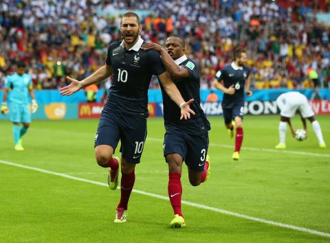 Benzema celebrates with Patrice Evra after scoring France's first goal against Honduras.