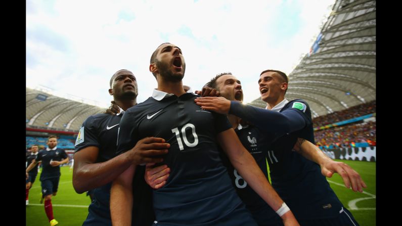 France forward Karim Benzema, second left, celebrates with teammates after scoring his <a href="index.php?page=&url=https%3A%2F%2Fwww.cnn.com%2F2014%2F06%2F12%2Ffootball%2Fgallery%2Fworld-cup-goals%2Findex.html" target="_blank">team's first goal</a> against Honduras with a penalty kick.