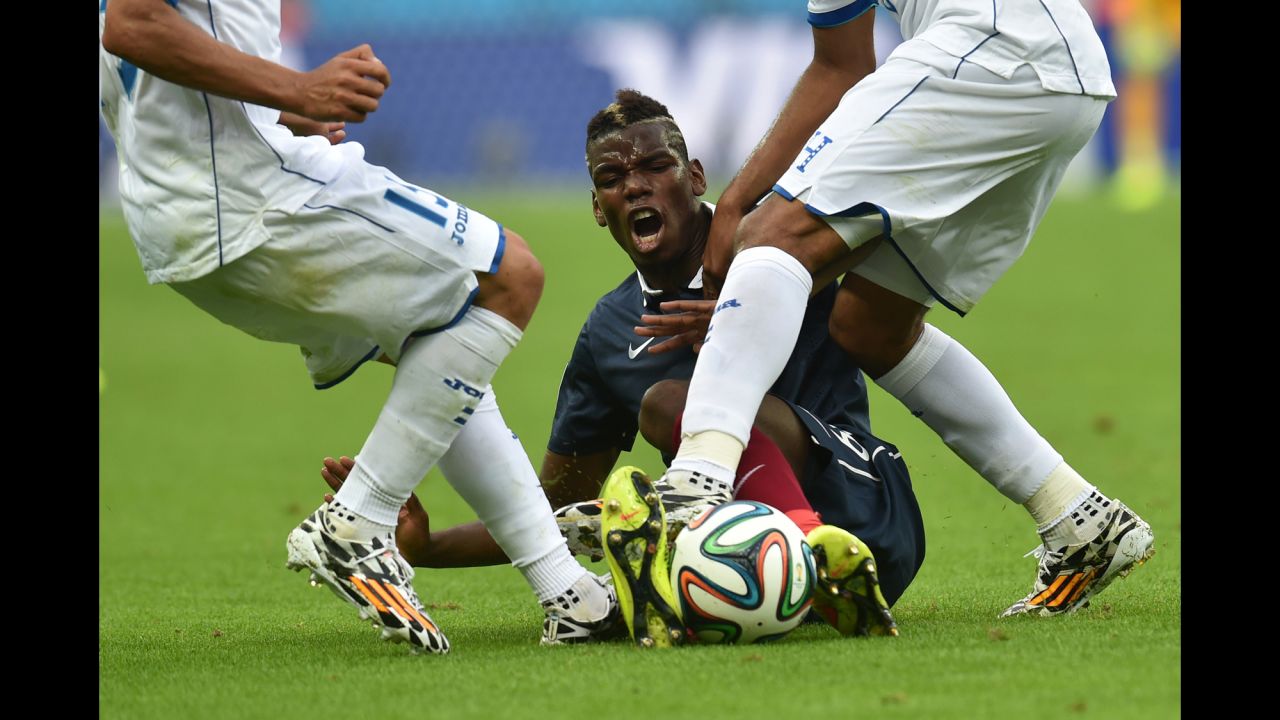France midfielder Paul Pogba is tackled by Honduras' Wilson Palacios, right.