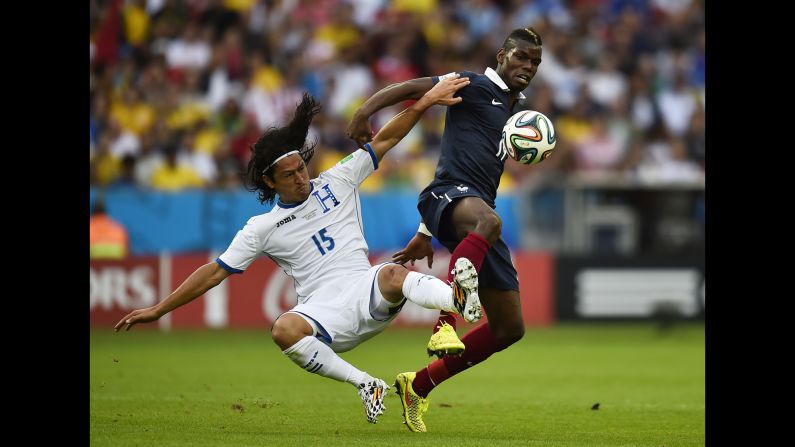 Honduras midfielder Roger Espinoza, left,  vies with France's Paul Pogba.