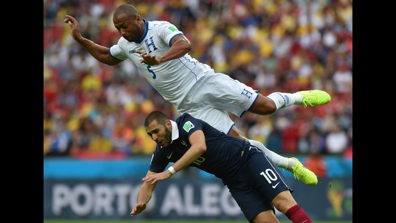 Honduras defender Victor Bernardez falls over France forward Karim Benzema.