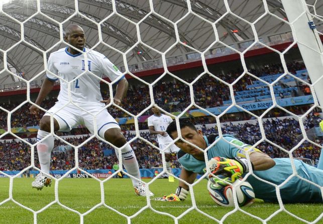 Honduras goalkeeper Noel Valladares, right, scores an unfortunate own goal after a shot by Benzema rebounded off the post. It was confirmed by FIFA's new goal-line technology.