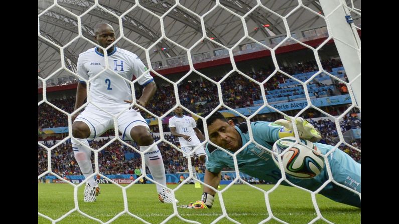 Honduras' captain Noel Valladares, right, scores an own goal after a shot by France's Karim Benzema hits the post and rebounds off the goalkeeper and over the line.