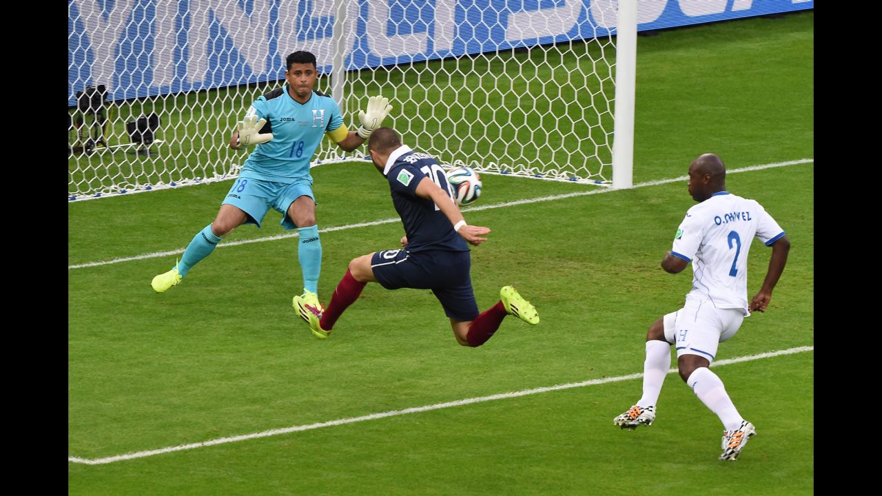 France forward Karim Benzema, center,  shoots past Honduras' goalkeeper Noel Valladares.